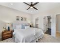 Relaxing main bedroom featuring a large window, ceiling fan, and ensuite bathroom access at 1473 N Locust St, Denver, CO 80220