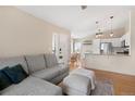 Open floor plan showcasing a cozy living room flowing into a well-equipped kitchen and dining area at 8615 W Berry Ave # 203, Littleton, CO 80123