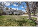 Well-maintained single-Gathering home with a lush lawn, mature trees, and a fenced yard at 17802 E Bates Ave, Aurora, CO 80013