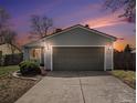 Charming home featuring a two-car garage with a concrete driveway and manicured landscaping at 17802 E Bates Ave, Aurora, CO 80013