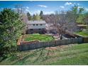 Aerial view of a fenced backyard with mature trees and a well-maintained lawn at 9787 W Ohio Ave, Lakewood, CO 80226