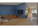 Inviting living room featuring hardwood floors, stylish furnishings, and an open concept design at 21518 E Powers Ln, Centennial, CO 80015
