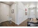 Welcoming home entryway boasting wood floors, accent wall trim and natural light flowing through at 15776 Native Willow Dr, Monument, CO 80132