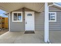 Up-close view of the front door with decorative glass, a security camera, and a 'Welcome' mat at 1533 E Harlan, Lakewood, CO 80214