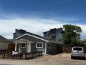 Inviting single-story residence with gray siding, a manicured yard, and convenient parking space at 1533 E Harlan, Lakewood, CO 80214