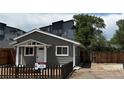 Charming single-story house with well-kept yard and clear 'For Sale' sign at 1533 E Harlan, Lakewood, CO 80214