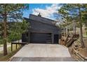Spacious garage and driveway, adjacent to rear patio and home entrance at 6640 Kilimanjaro Dr, Evergreen, CO 80439