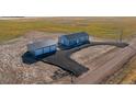 Beautiful aerial view of the single-story home with a long driveway, and a detached garage, surrounded by farmland at 6 Timberlake Ct, Byers, CO 80103