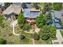 An aerial view of the house, showcasing its backyard, patio, and surrounding greenery at 6457 Willow Broom Trl, Littleton, CO 80125