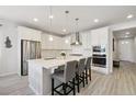 Modern kitchen with stainless steel appliances, a center island, and sleek white cabinetry at 171 S Waterloo St, Aurora, CO 80018