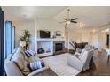 Comfortable living room with a stone fireplace, plush seating, and a ceiling fan at 5350 Clearbrooke Ct, Castle Rock, CO 80104