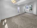 A spacious living room with carpet, high ceilings, and many windows at 10707 Milliken St, Parker, CO 80134