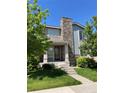 Charming two-story home with inviting front porch and well-maintained lawn at 15437 W 95Th Ave, Arvada, CO 80007