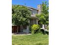Beautiful two-story home featuring manicured lawn and mature trees at 15437 W 95Th Ave, Arvada, CO 80007