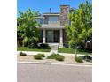 Inviting two-story home with stone accents, manicured lawn and lush landscaping at 15437 W 95Th Ave, Arvada, CO 80007