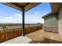 A backyard with a wood fence, professional landscaping, and a concrete patio at 21044 E 63Rd Dr, Aurora, CO 80019