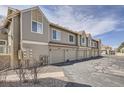 Townhouse garages offer convenient parking with a well-maintained driveway and landscaping at 7373 E Iowa Ave # 1112, Denver, CO 80231