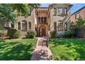 Charming home featuring a manicured lawn, quaint front entry, and warm curb appeal at 1640 N Downing St # 103, Denver, CO 80218