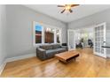 Bright living room with hardwood floors, a gray sofa, and French doors leading to an office at 1640 N Downing St # 103, Denver, CO 80218
