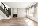 Bright living room features new floors, a fireplace, and a staircase to the upper level at 1279 S Sable Blvd, Aurora, CO 80012