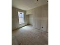 Bedroom under construction featuring natural light from window and closet space at 30 Waterford St, Erie, CO 80516