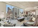 Spacious living room featuring floor-to-ceiling windows with panoramic city views and stylish furnishings at 891 14Th St # 1408, Denver, CO 80202
