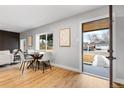 Bright dining area featuring hardwood floors, modern decor, and a view of the outdoors at 3210 Magnolia St, Denver, CO 80207