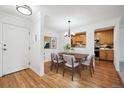Cozy dining area with wood floors, a chandelier, and a view into the kitchen at 660 S Alton Way # 3B, Denver, CO 80247
