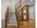 Elegant foyer showcases a staircase with wooden railings, complemented by hardwood and carpeted floors at 5276 S Danube St, Centennial, CO 80015