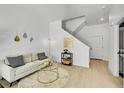 Bright living room with modern décor, a comfortable sofa, and a stylish round glass coffee table at 8530 W 52Nd Ave # A1, Arvada, CO 80002