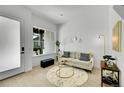 Inviting living room featuring natural light, a cozy sofa, and minimalist decor for a modern aesthetic at 8530 W 52Nd Ave # A1, Arvada, CO 80002
