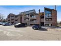 Condos feature brick accents, balconies, and parking, creating an inviting exterior, complemented by blue skies at 12360 W Nevada Pl # 206, Lakewood, CO 80228