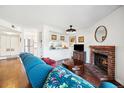 Inviting living room with a brick fireplace, wood floors, and a comfortable sofa, perfect for relaxation at 12360 W Nevada Pl # 206, Lakewood, CO 80228