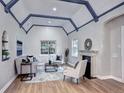 Bright living room with vaulted ceilings, exposed beams, fireplace, and hardwood floors at 1378 Forest St, Denver, CO 80220