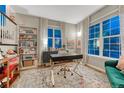 Bright office space with large windows, a modern desk, and stylish decor and a bookcase at 13053 Umatilla Ct, Denver, CO 80234