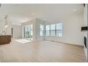 Bright and airy living room with hardwood floors, large windows, and modern fireplace at 910 Promenade Dr, Superior, CO 80027