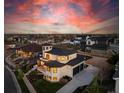 Expansive aerial view of a modern home with a sleek design in a residential neighborhood, set against a dramatic sky at 8240 W Tennessee Ave, Lakewood, CO 80226