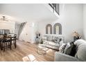 Bright living room area features stylish decor, hardwood floors, and an adjacent dining area at 3231 S Estes St, Lakewood, CO 80227