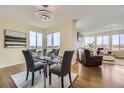 Bright dining area with modern light fixture, large windows, and seating for four, great for gatherings at 12291 Coral Burst Ct, Parker, CO 80134