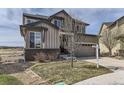 Charming two-story home with a well-manicured lawn and beautifully landscaped yard at 12291 Coral Burst Ct, Parker, CO 80134