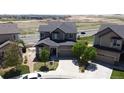 Two-story home with an attached garage, well-maintained lawn, and manicured landscaping, creating inviting curb appeal at 12291 Coral Burst Ct, Parker, CO 80134