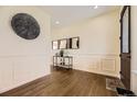 Elegant foyer featuring hardwood floors, decorative wall paneling, and stylish decor at 12291 Coral Burst Ct, Parker, CO 80134