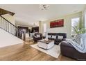 Open-concept living room with hardwood floors and ample natural light, perfect for entertaining and relaxing at 12291 Coral Burst Ct, Parker, CO 80134