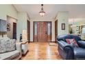 Bright entryway with hardwood floors and wood door at 8272 Bighorn Ct, Lone Tree, CO 80124