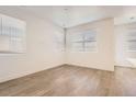 Bright bedroom with sleek laminate floors, white walls and three large windows providing natural light at 4327 E 98Th Pl, Thornton, CO 80229