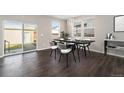 Dining area featuring hardwood floors, modern lighting, and sliding glass door to backyard at 2409 W 38Th Ave, Denver, CO 80211
