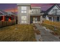Modern two-story home with stone accents, balcony, xeriscaped front yard, and concrete steps at 2409 W 38Th Ave, Denver, CO 80211