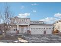 Charming two-story home with three-car garage, landscaped front yard, and welcoming front porch at 4844 Mt Evans St, Brighton, CO 80601