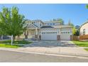 Beautiful home with covered porch, three car garage, well-kept lawn, and a lovely setting at 4844 Mt Evans St, Brighton, CO 80601