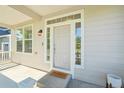 Welcoming front porch with charming 'Oh, Hello' doormat and bright windows at 4844 Mt Evans St, Brighton, CO 80601